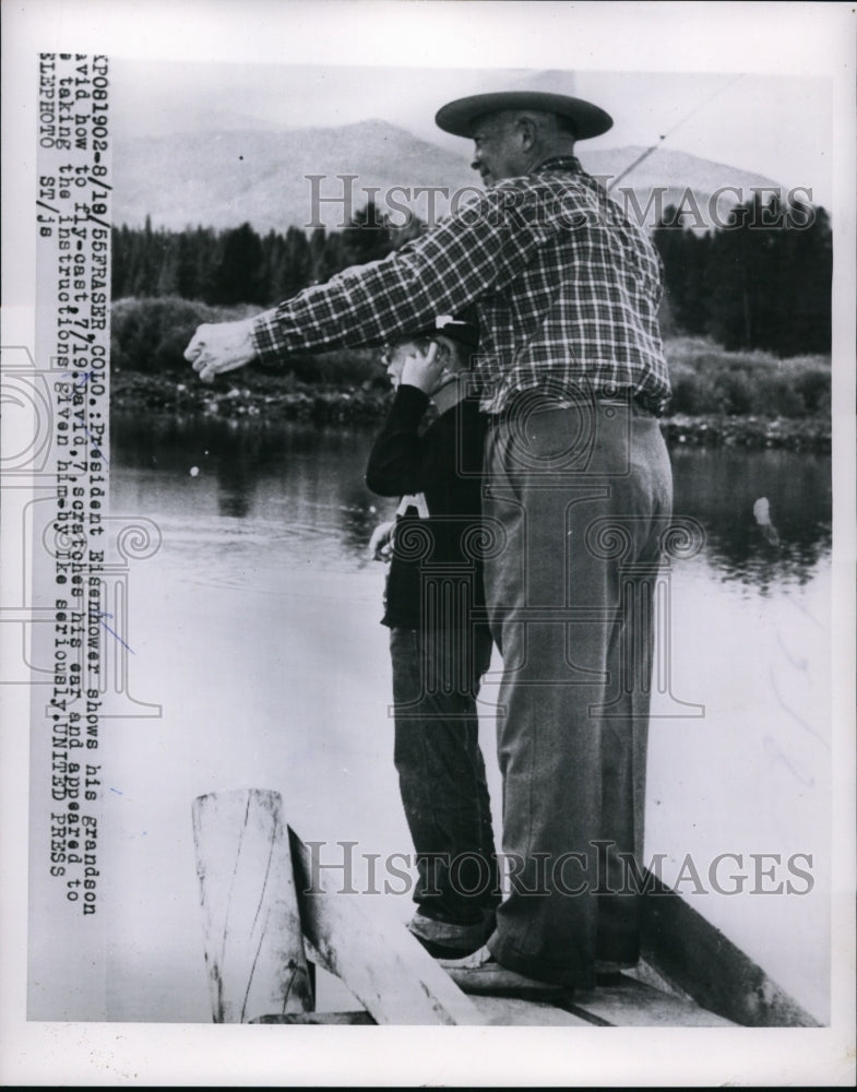 Load image into Gallery viewer, 1955 Press Photo President Eisenhower shows his grandson how to fly-cast
