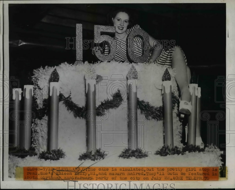 1946 Press Photo Eileen Kelly poses atop 150th birthday cake for Cleveland