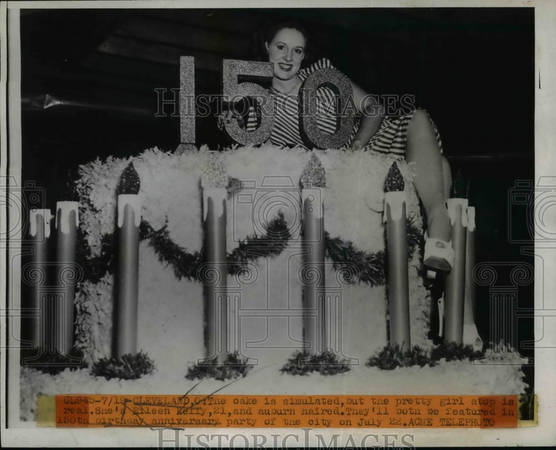 Load image into Gallery viewer, 1946 Press Photo Eileen Kelly poses atop 150th birthday cake for Cleveland
