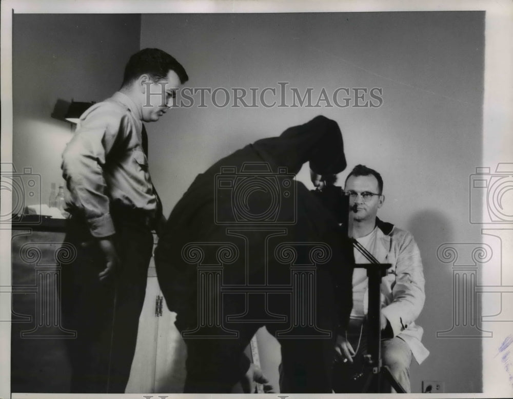 1958 Press Photo Chicago policeman George Michaletti sits in front of camera