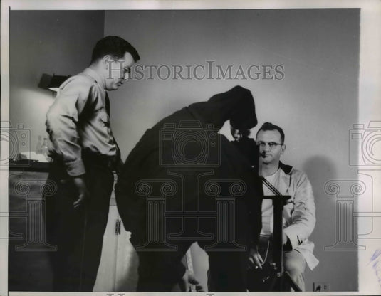 1958 Press Photo Chicago policeman George Michaletti sits in front of camera