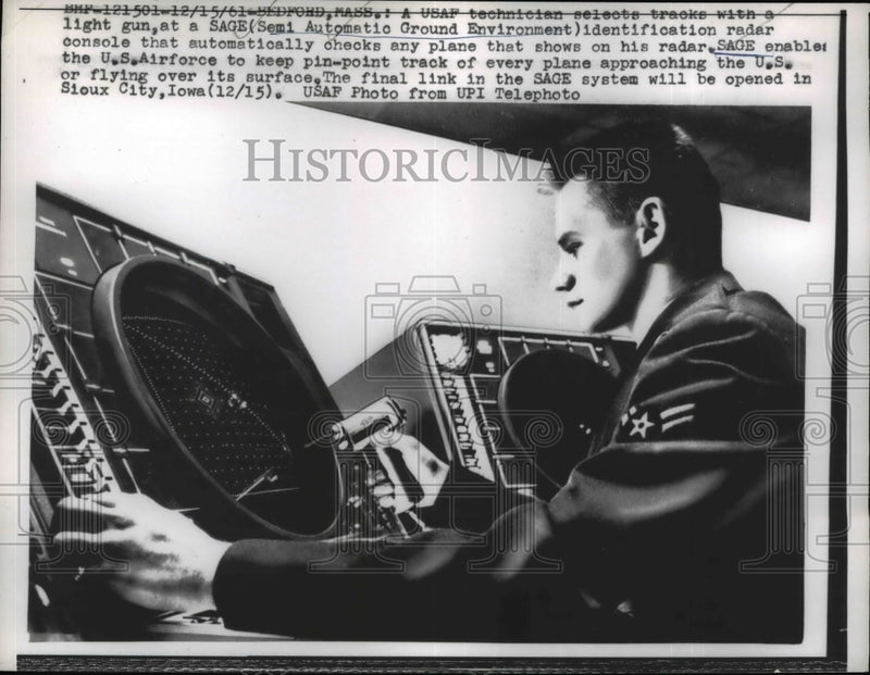 Load image into Gallery viewer, 1961 Press Photo USAF technician selects tracks for light gun at SAGE terminal
