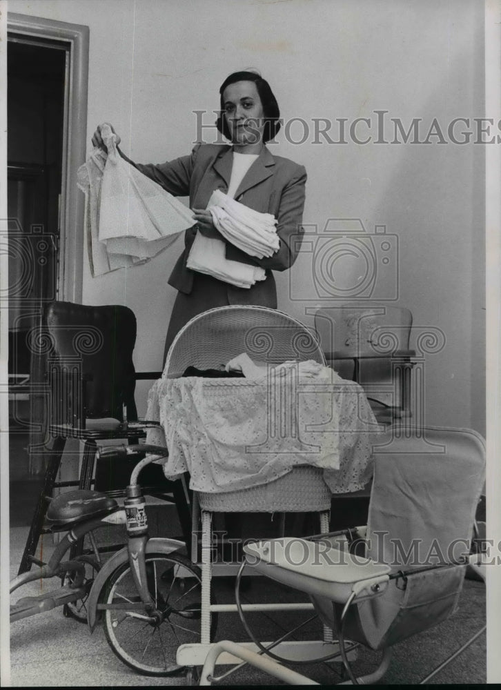 1961 Press Photo Mrs. Howard D. Sauder with Baby &amp; Children&#39;s Items - nef03040