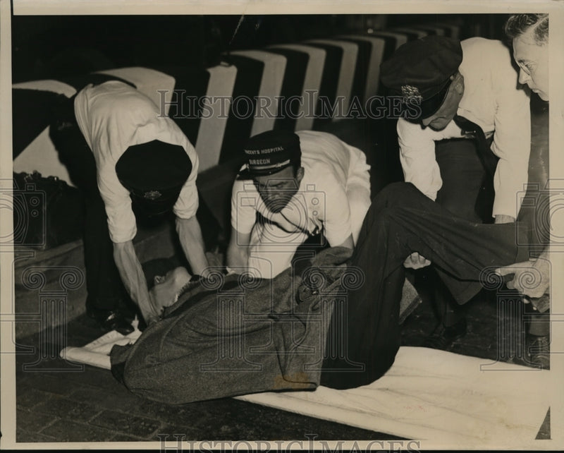 Load image into Gallery viewer, 1937 Press Photo John O'Connor Being Helped Onto Stretcher After Car Accident
