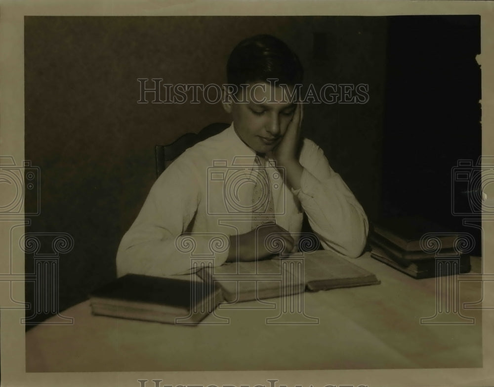1934 Press Photo Charles Chapley reads a book at table - nef10586