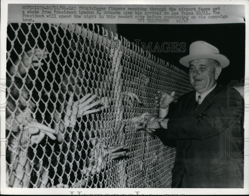 Load image into Gallery viewer, 1964 Press Photo Lyndon B. Johnson Shaking Hands Through Fence, Las Vegas
