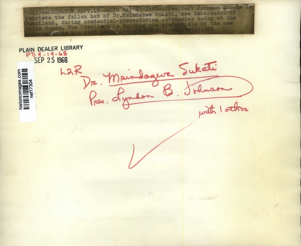 1968 Press Photo Pres.Lyndon Johnson get the fallen hat of Dr.