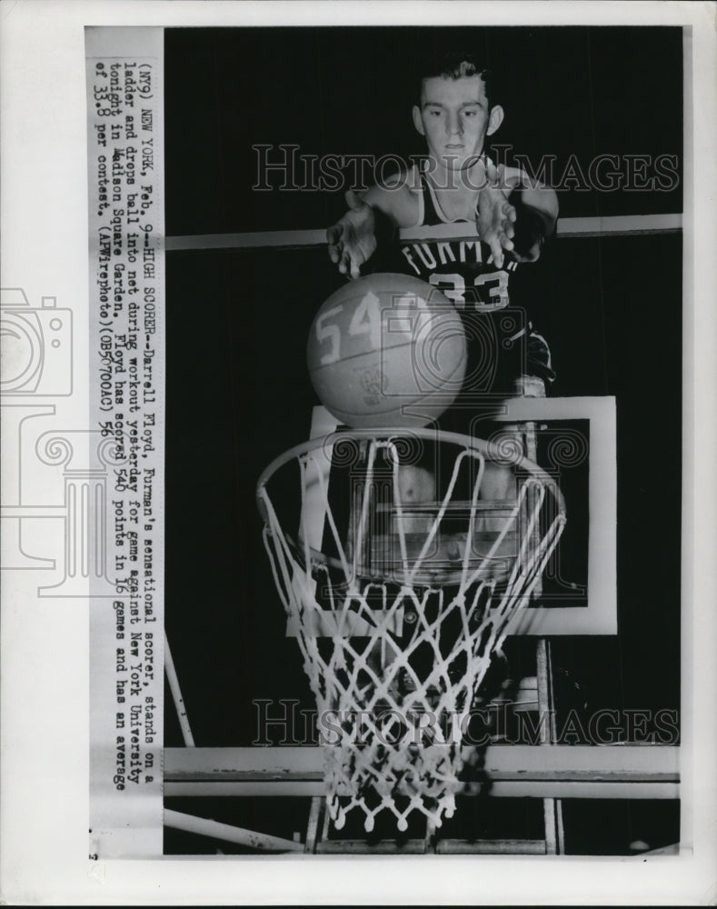 1956 Press Photo Floyd stands on a ladder and drops ball into net during workout- Historic Images