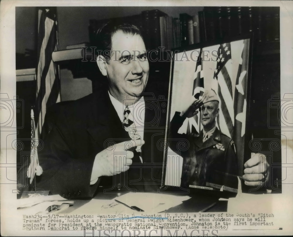 1948 Press Photo Sen.Olin D.Johnson holds pictures of Gen. Dwight Eisenhower