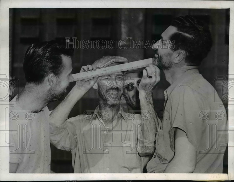 Load image into Gallery viewer, 1945 Press Photo Goodrich Rubber Co Workers measure their Tonsorial efforts
