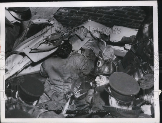 1950 Press Photo Firemen Work In Space Between Factory Wall and Switch Engine