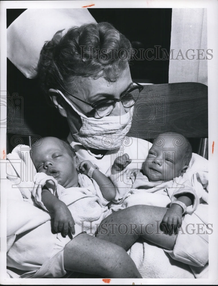 Load image into Gallery viewer, 1959 Press Photo Mrs.Mary Miszerwski R.N. at Grace Hospital holds a twins
