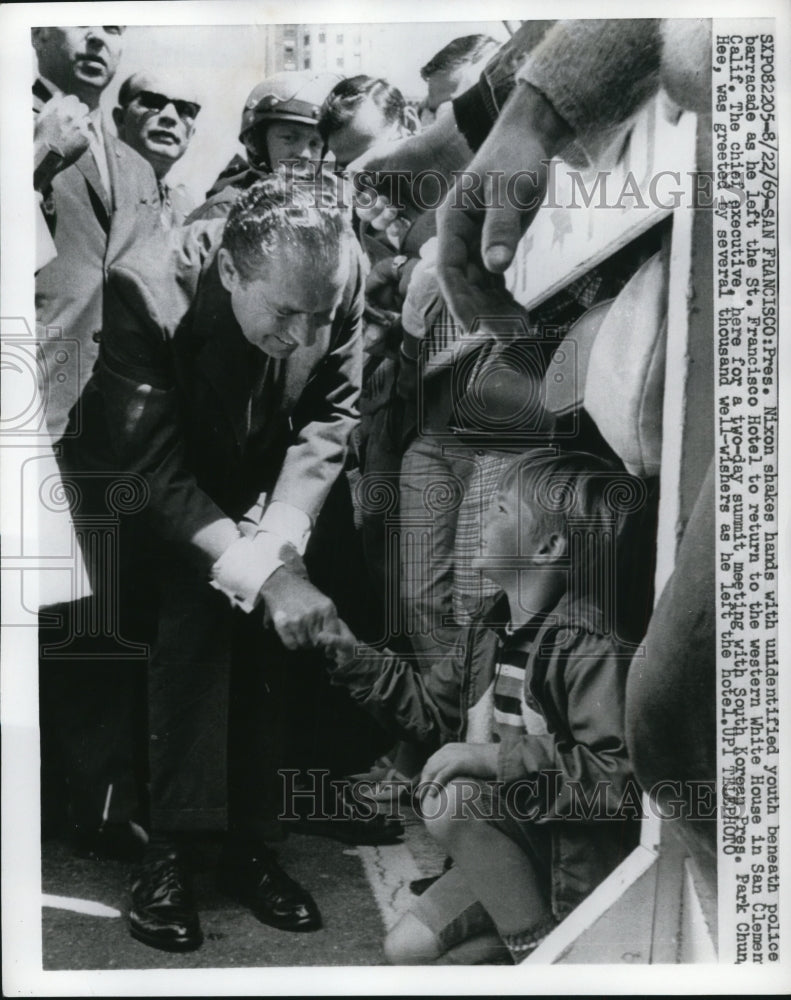 Load image into Gallery viewer, 1969 Press Pres Nixon Shakes Hands With Unidentified Youth Beneath Barracade
