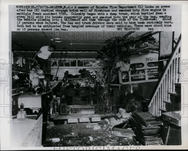 Load image into Gallery viewer, 1959 Press Photo Fireman looking over wreckage of a firehouse - nef26327
