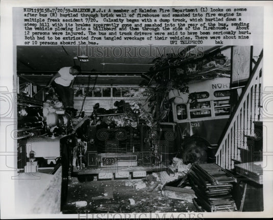 1959 Press Photo Fireman looking over wreckage of a firehouse - nef26327