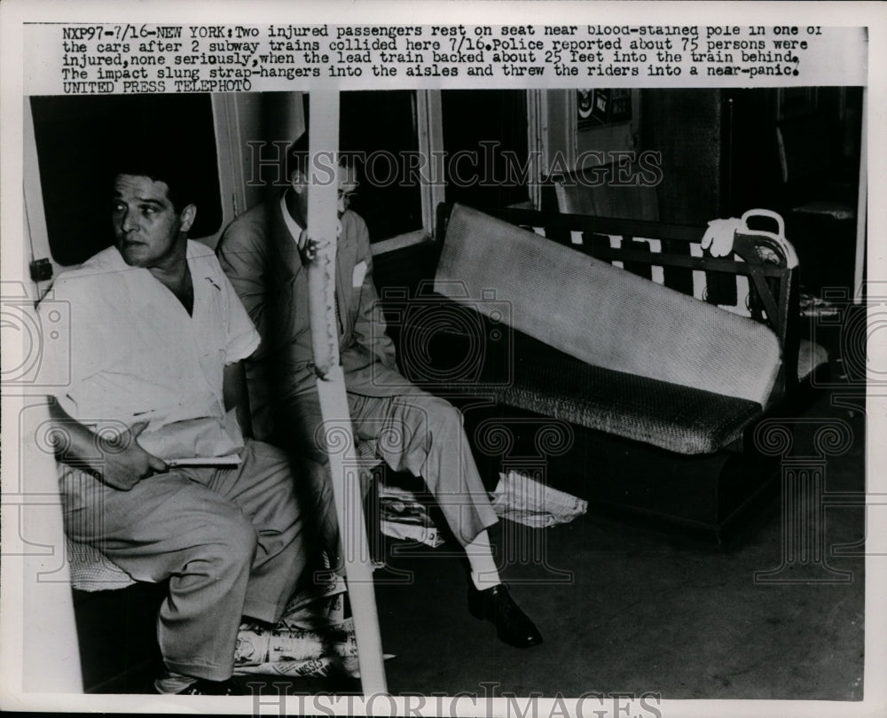 1952 Press Photo Two injured passengers rest on seat near blood-stained pole