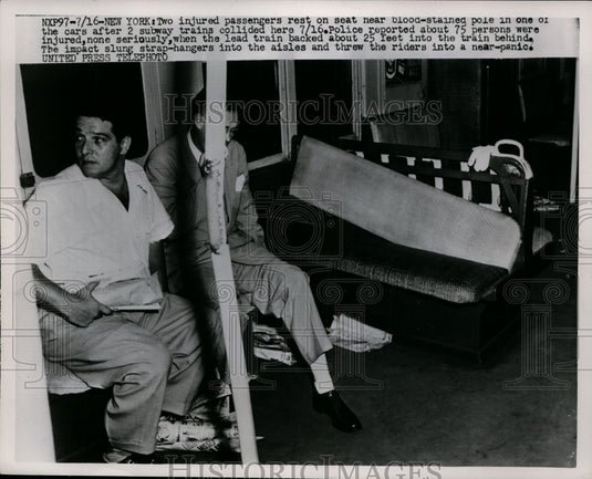 1952 Press Photo Two injured passengers rest on seat near blood-stained pole