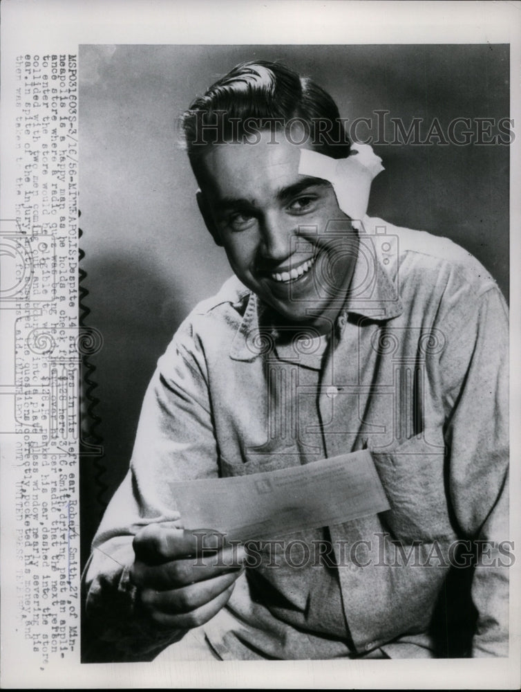 1956 Press Photo Robert Smith holds a check for winning in the radio quiz