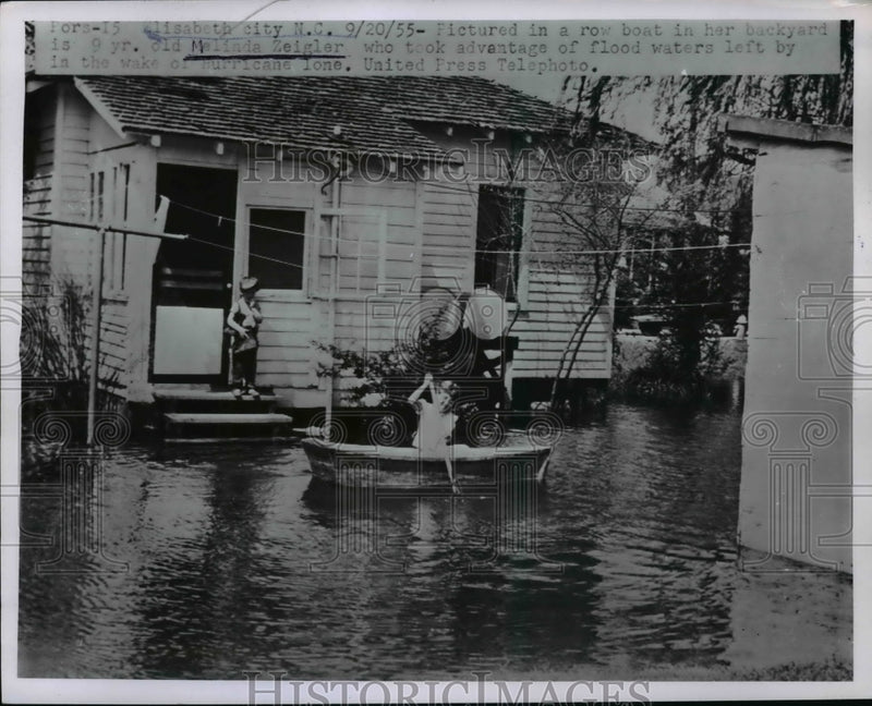 Load image into Gallery viewer, 1955 Press Photo 9 YO Melinda Zeigler Takes Advantage of Hurricane Lone's Floods
