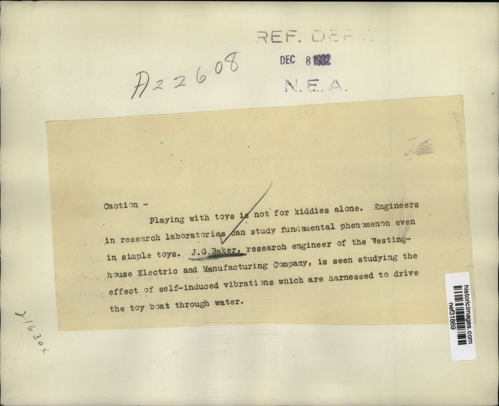 1932 Press Photo J.G. Baker of Westinghouse Electric Company Studies Toy Boat