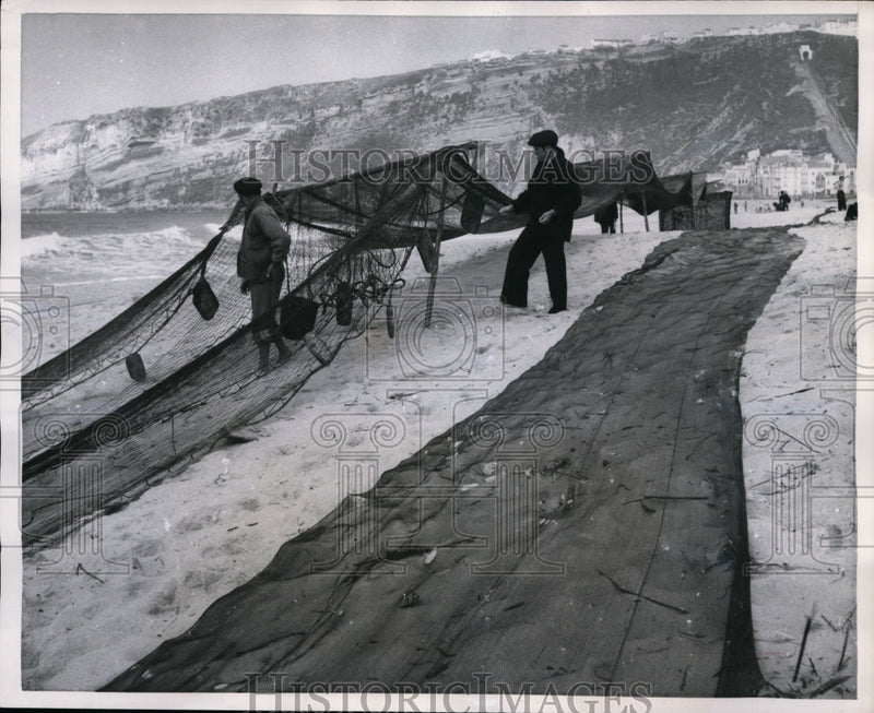 Load image into Gallery viewer, 1957 Press Photo Portugal- Men Spread Fishing Nets to Dry - nef31898
