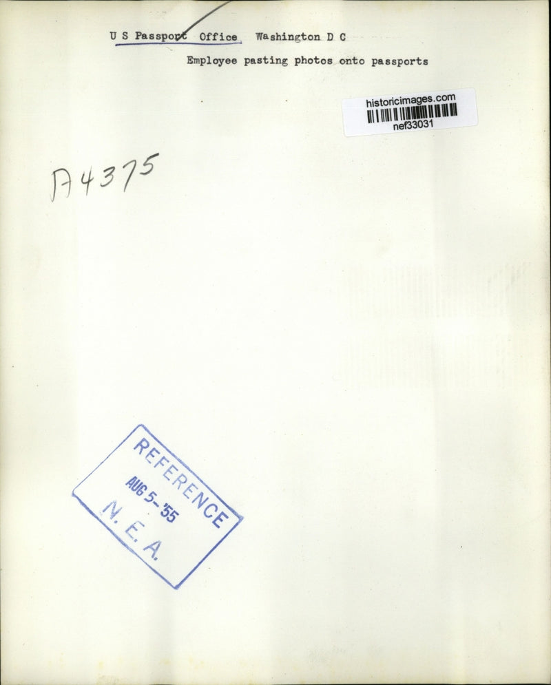 Load image into Gallery viewer, 1955 Press Photo Employee Pasting Photos Onto Passports - nef33031
