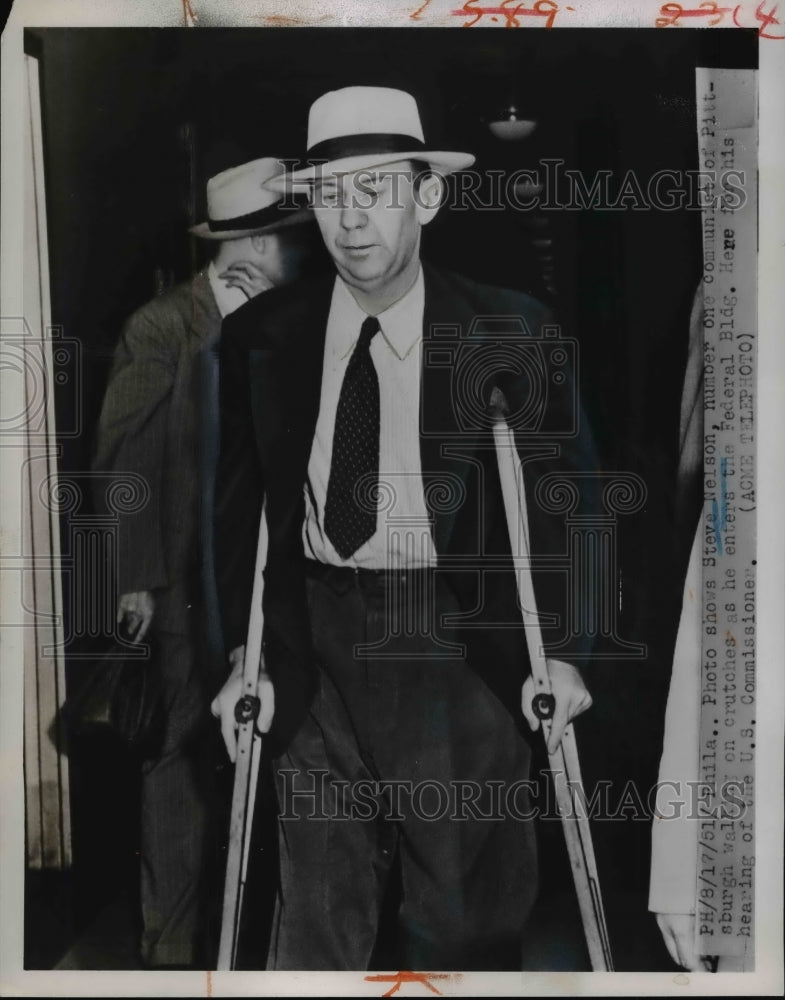 Load image into Gallery viewer, 1951 Press Photo Steve Nelson Walks on Crutches as He Enters Federal Building
