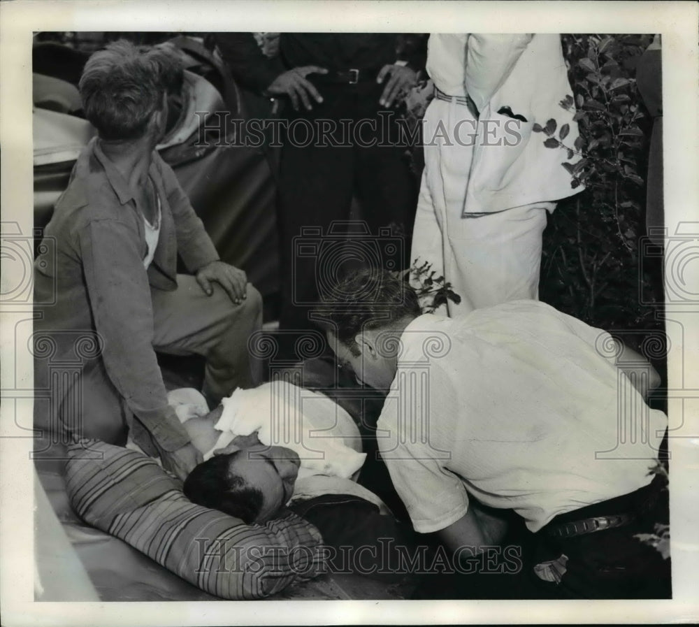 1941 Press Photo Doctor Works Over Carl Schwartz Injured From Biplane Crash