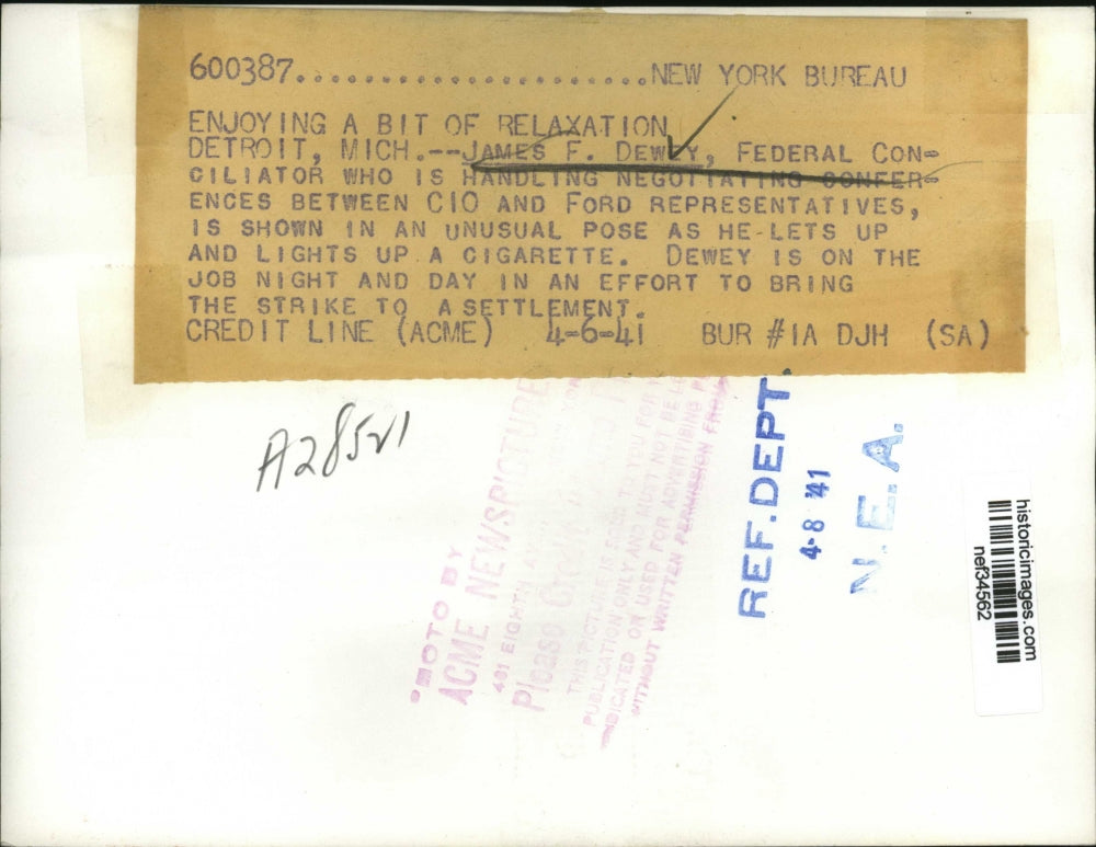 1941 Press Photo James F. Dewey Lighting Cigarette - nef34562