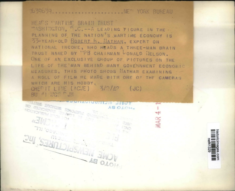 1942 Press Photo Robert R. Nathan Examining Roll of Film - nef41329