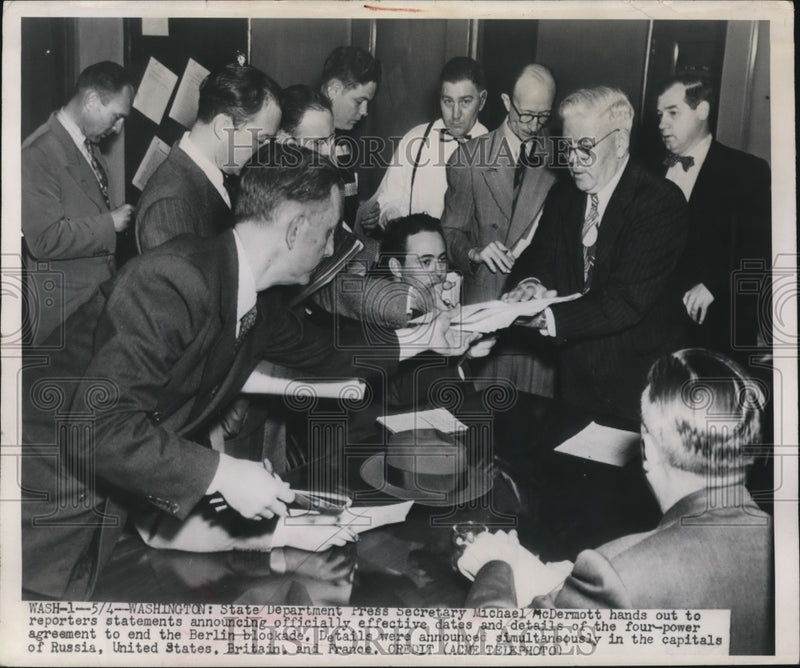 Load image into Gallery viewer, 1949 Press Photo Michael McDermott Hands Out Details of Four-Power Agreement
