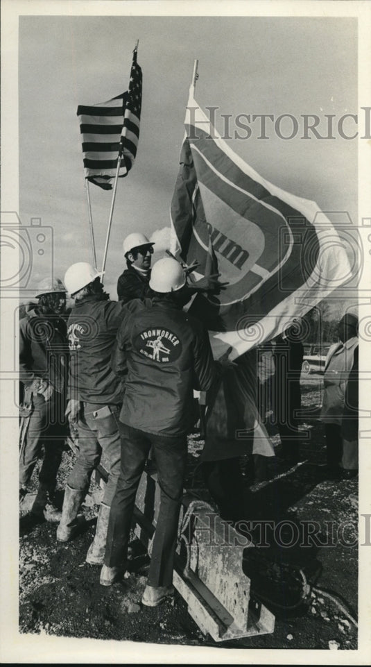 1973 Press Photo Flags Being Raised by Iron Workers - nef43848