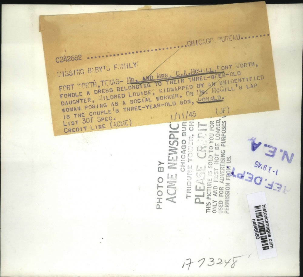 1945 Press Photo Mr. and Mrs. C.A. McGill fondle dress belonging to daughter