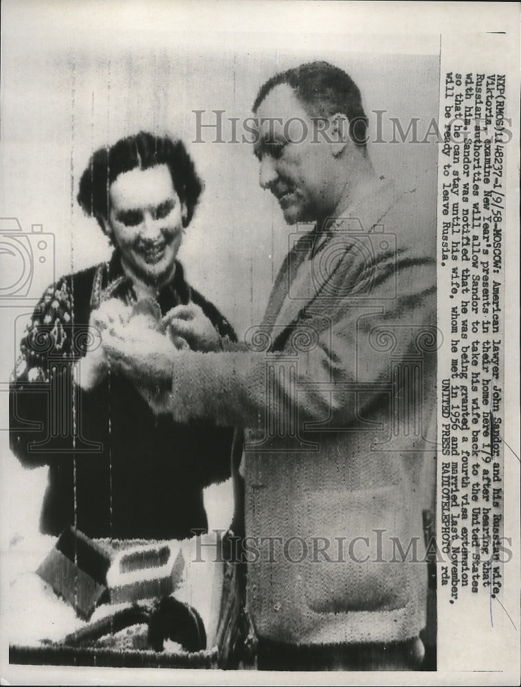 1958 Press Photo John Sandor & Wife Viktoria Examine New Year's Presents at Home