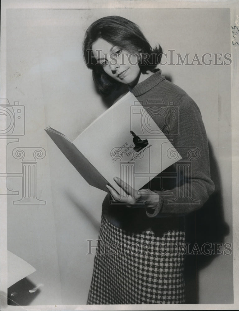 Load image into Gallery viewer, 1969 Press Photo Boston press photographer Teresa Zabala holding annual report
