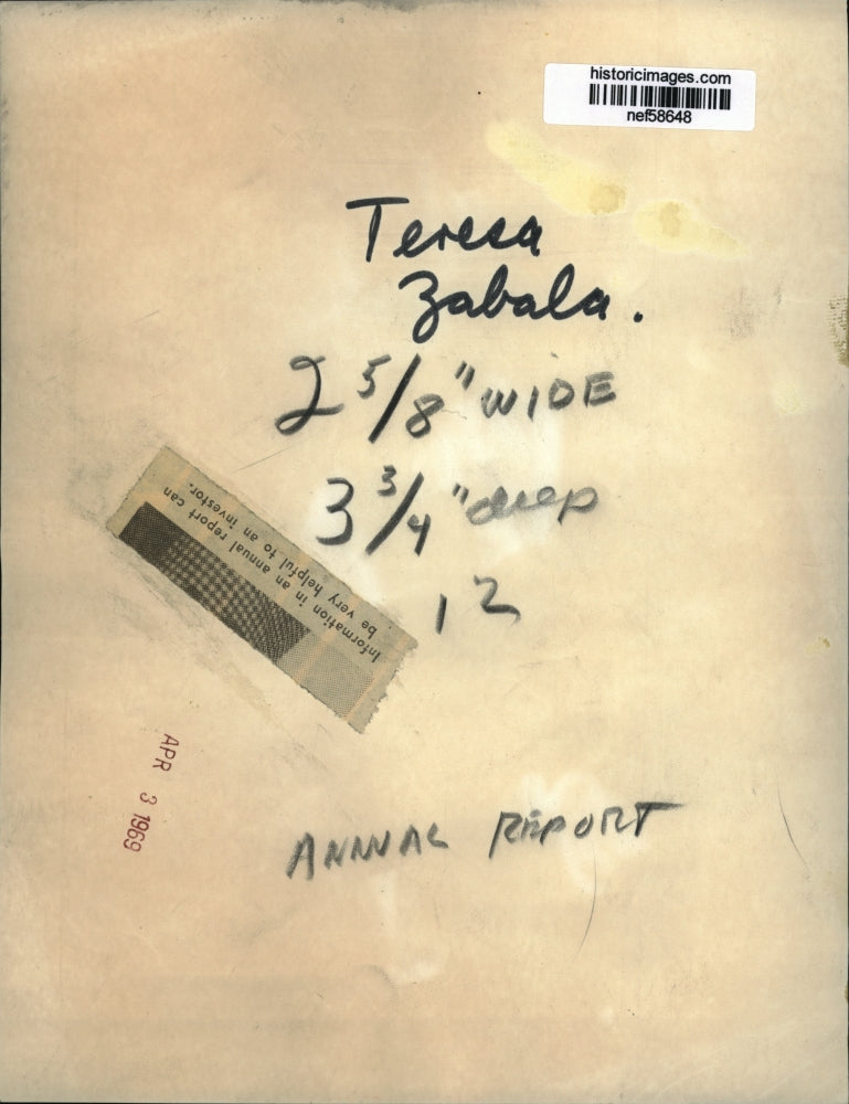 Load image into Gallery viewer, 1969 Press Photo Boston press photographer Teresa Zabala holding annual report
