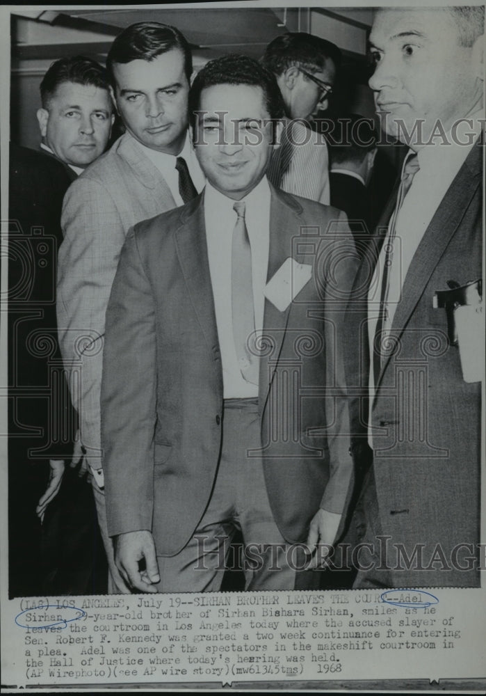 Load image into Gallery viewer, 1968 Press Photo Adel Sirhan smiles as he leaves the courtroom in Los Angeles
