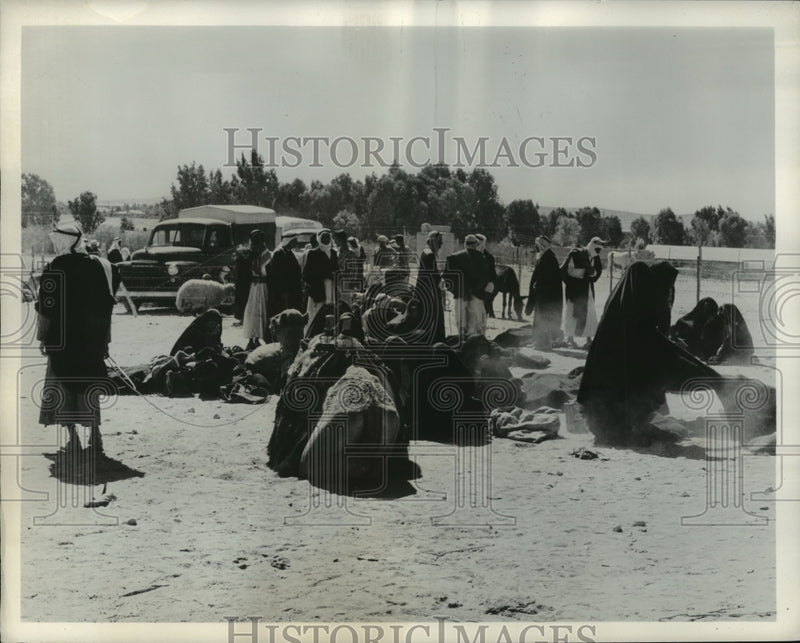 Load image into Gallery viewer, 1963 Press Photo Desert Bedouin Gathers in Open Marketplace for Business
