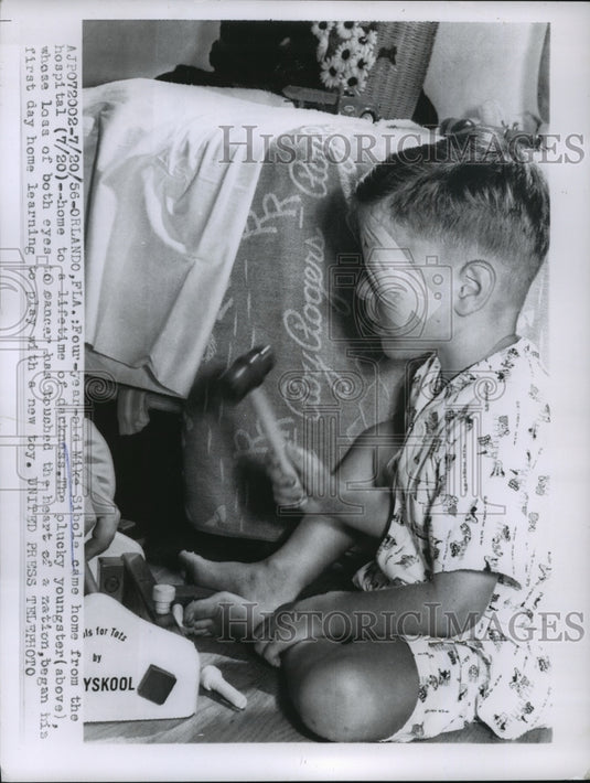 1956 Press Photo Mike Sibole learning to play with new toys with blindness