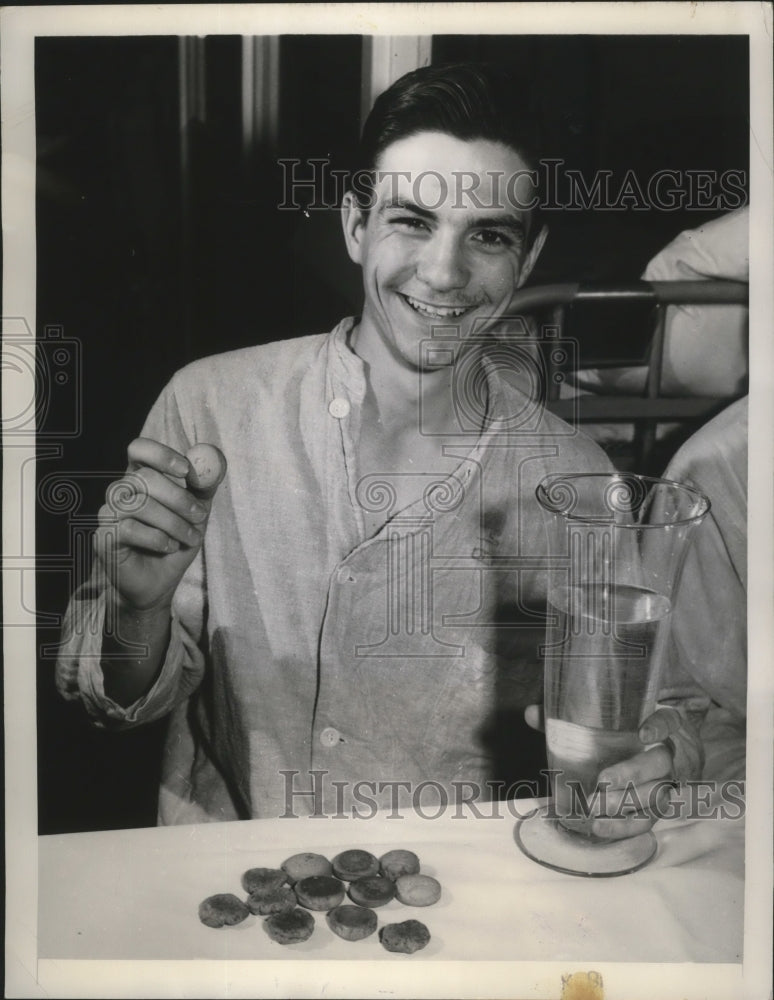 1948 Press Photo Army volunteer displays a day's ration of biscuits and water