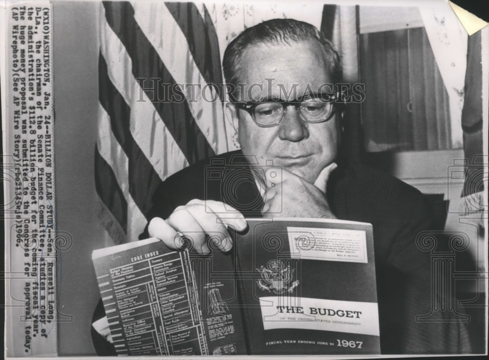 1966 Press Photo Sen.Russell Long studies $112.8 Billion Budget for fiscal year- Historic Images