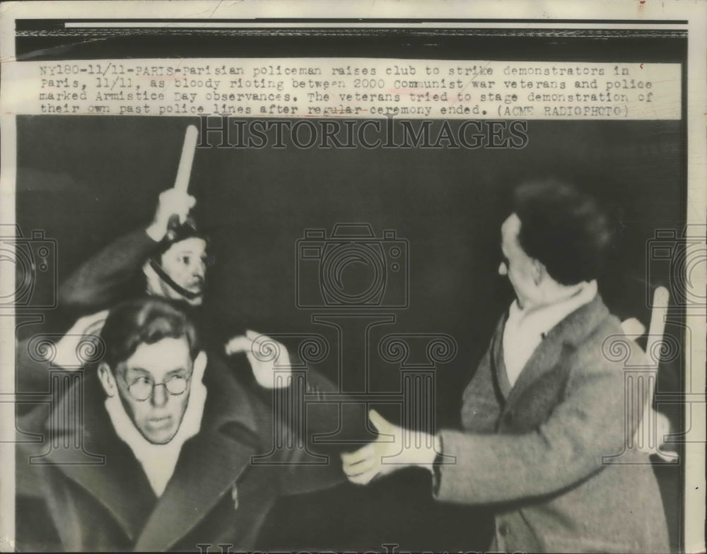 1948 Press Photo Parisian Policeman Raise Club to Strike Demonstrators in Paris