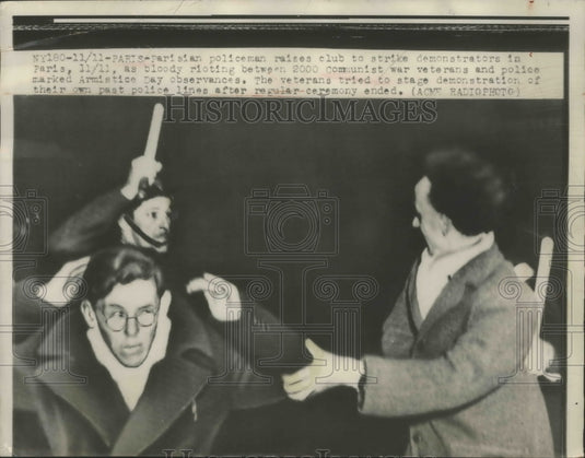 1948 Press Photo Parisian Policeman Raise Club to Strike Demonstrators in Paris