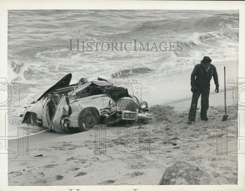 1945 Press Photo Man Looks Over Wreckage Which Hurled Into Ocean in Malibu Beach