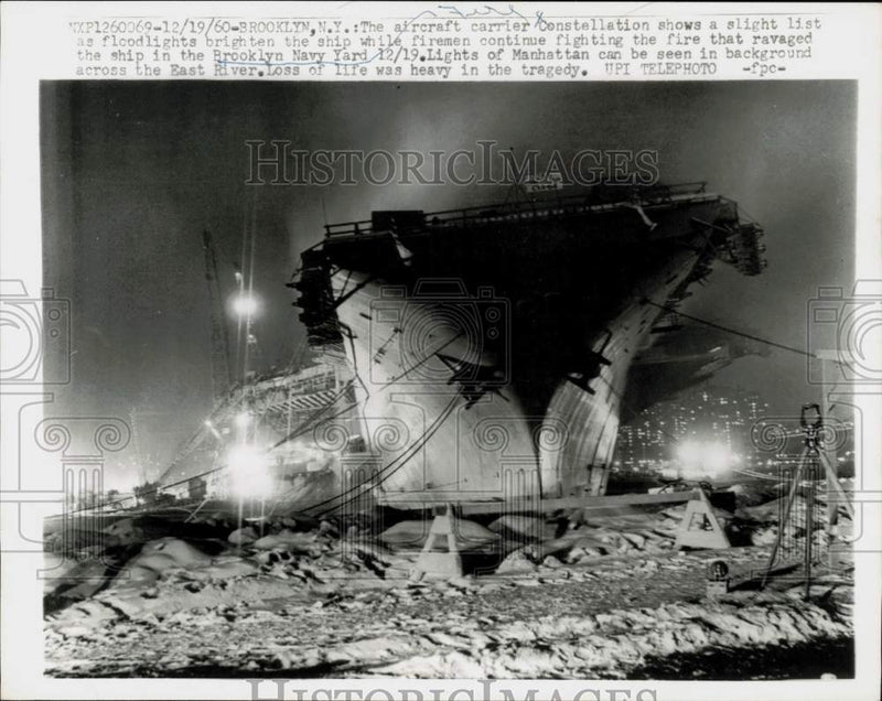 Load image into Gallery viewer, 1960 Press Photo Aircraft carrier Constellation lists as firemen battle fire, NY
