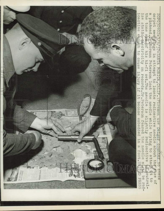 1957 Press Photo Firemen use Geiger counter to search for radioactive needle, CA- Historic Images