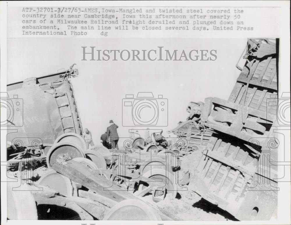 1963 Press Photo Men inspect wreckage of a train derailed near Cambridge, Iowa- Historic Images