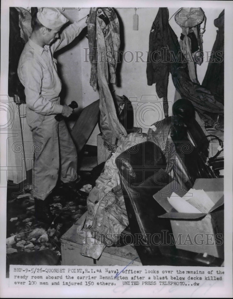 1954 Press Photo Quonset Point RI Naval officer& damage on USS Bennington