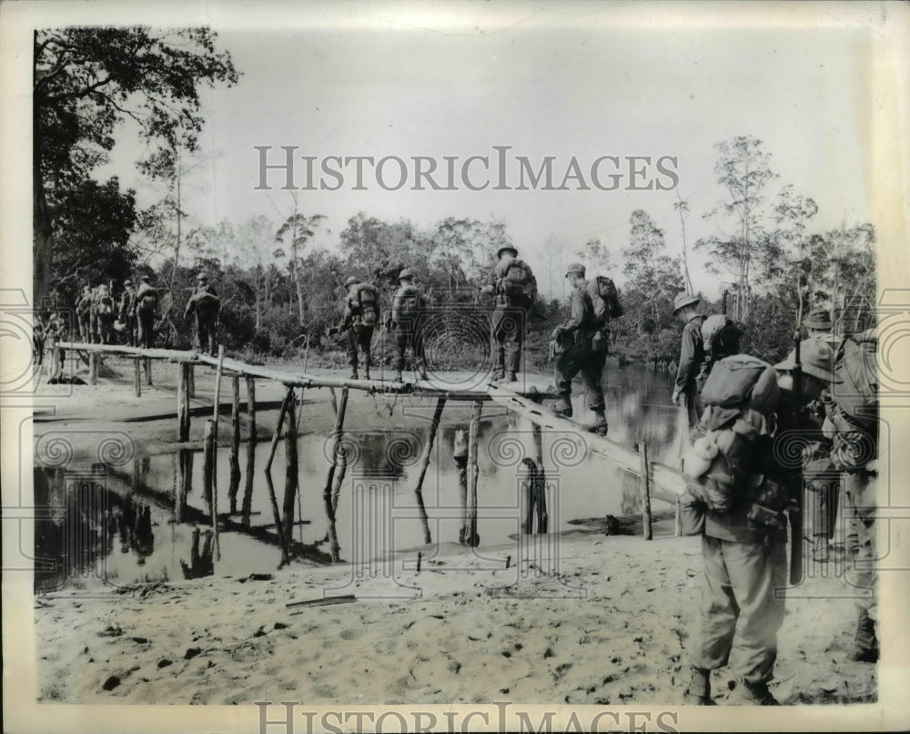 1942 Press Photo American Infantry Crosses a small bridge in New Guinea