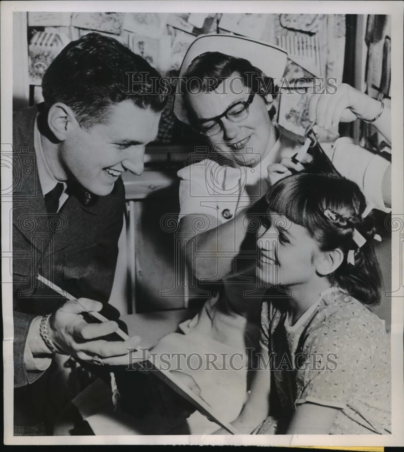 Load image into Gallery viewer, 1952 Press Photo Bruce Montgomery and Children's Hospital nurse with a patient
